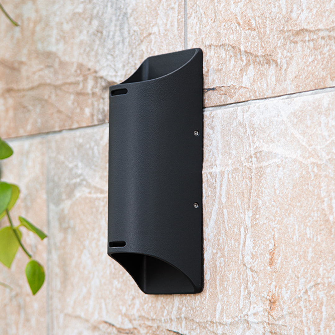 Elegant residential entrance featuring symmetrical black wall lights flanking rich wooden door with planters