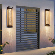 Outdoor sconces black illuminating a residential entrance, creating a welcoming and stylish ambiance.