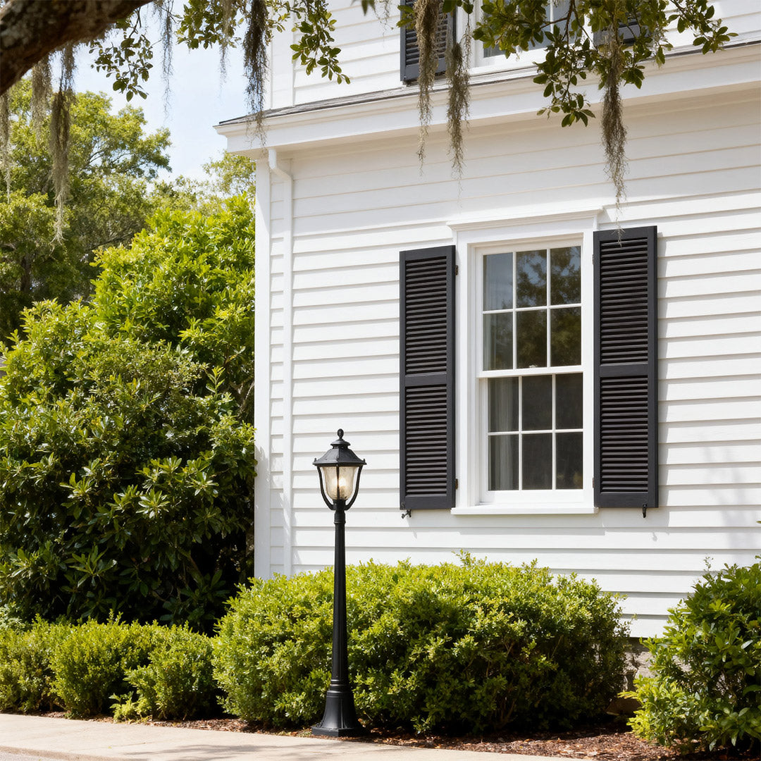 Bollard post light in a residential garden, warm and inviting outdoor lighting fixture
