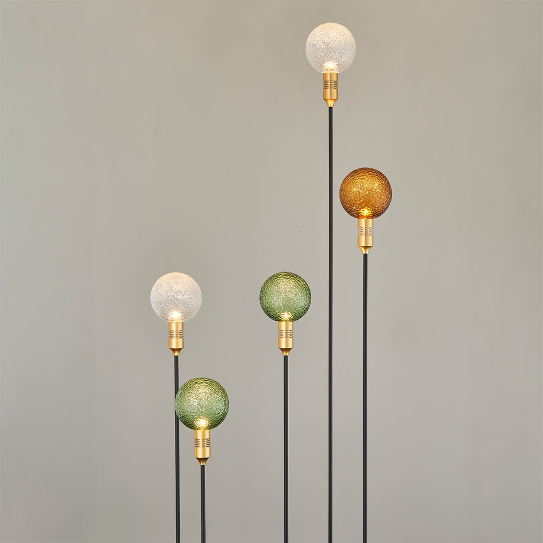 Warm-toned crackle globe garden stakes lighting a pathway in a residential landscape.
