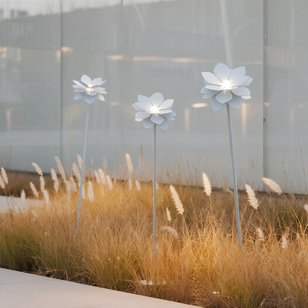 Contemporary residential landscape garden lights display featuring multiple white flower fixtures in modern yard setting
