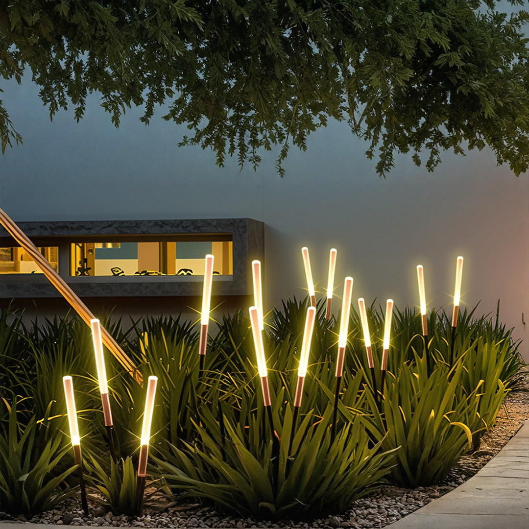 Modern residential landscape spike light setup with multiple fixtures providing elegant pathway and accent lighting