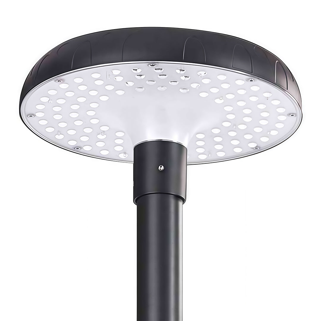 Energy-efficient residential streetlight shining brightly on a sidewalk in a neighborhood.