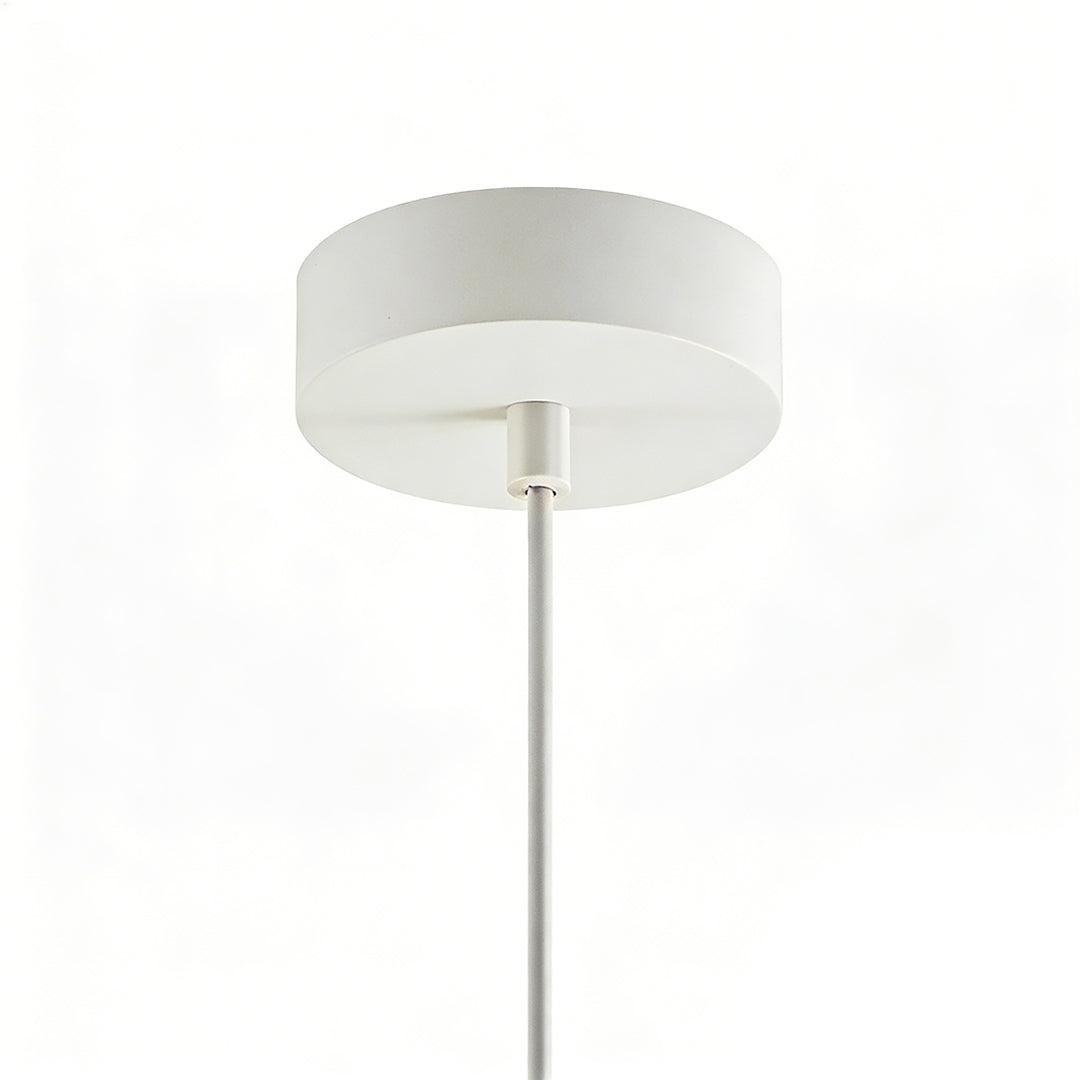 Resin pendant light in white, featuring a smooth surface and hanging in a minimalist interior.