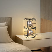 Retail display cube table lamp in modern clothing store with geometric frame accent lighting