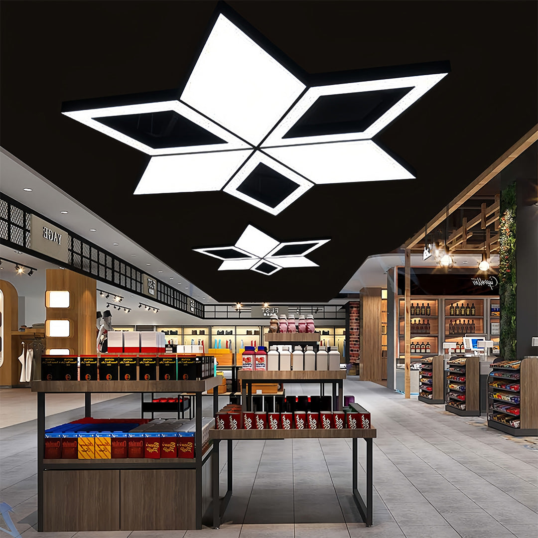 A modern black chandelier installed in a retail space, featuring geometric lighting elements for a dynamic visual effect.