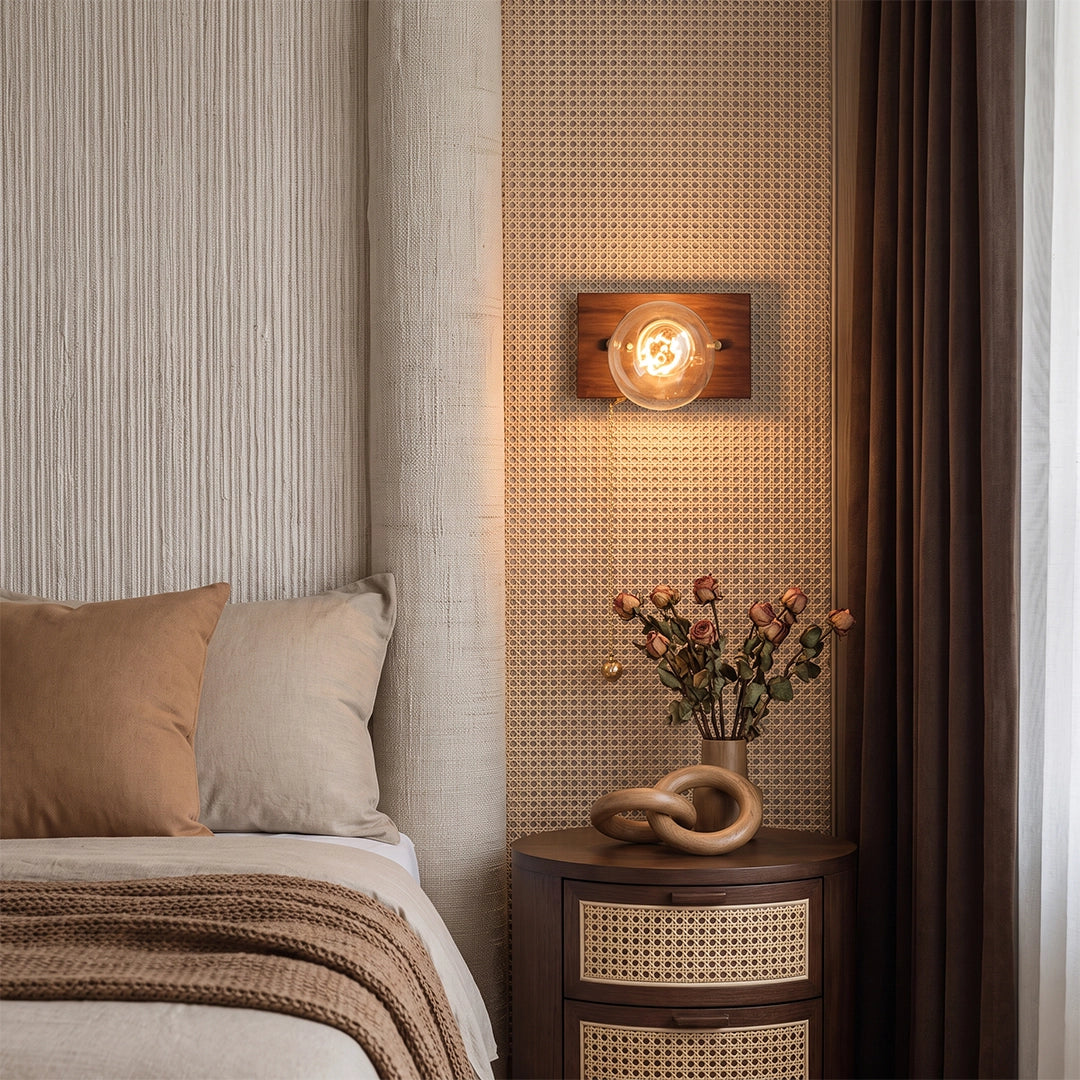 Retro bedside wall light mounted above a nightstand in a cozy bedroom with woven textures and warm decor.