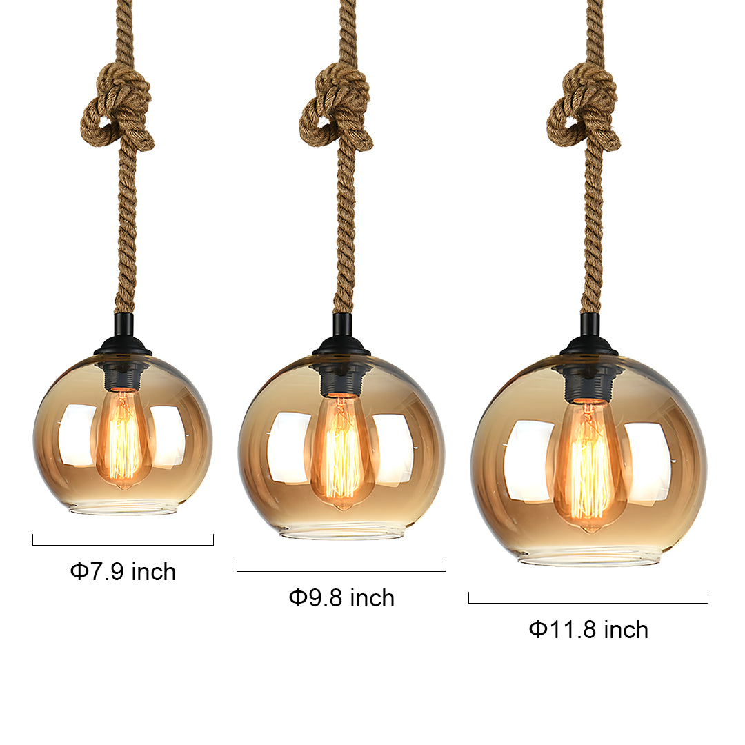 Three retro glass pendant lights with amber globes and rope cord suspension in size comparison