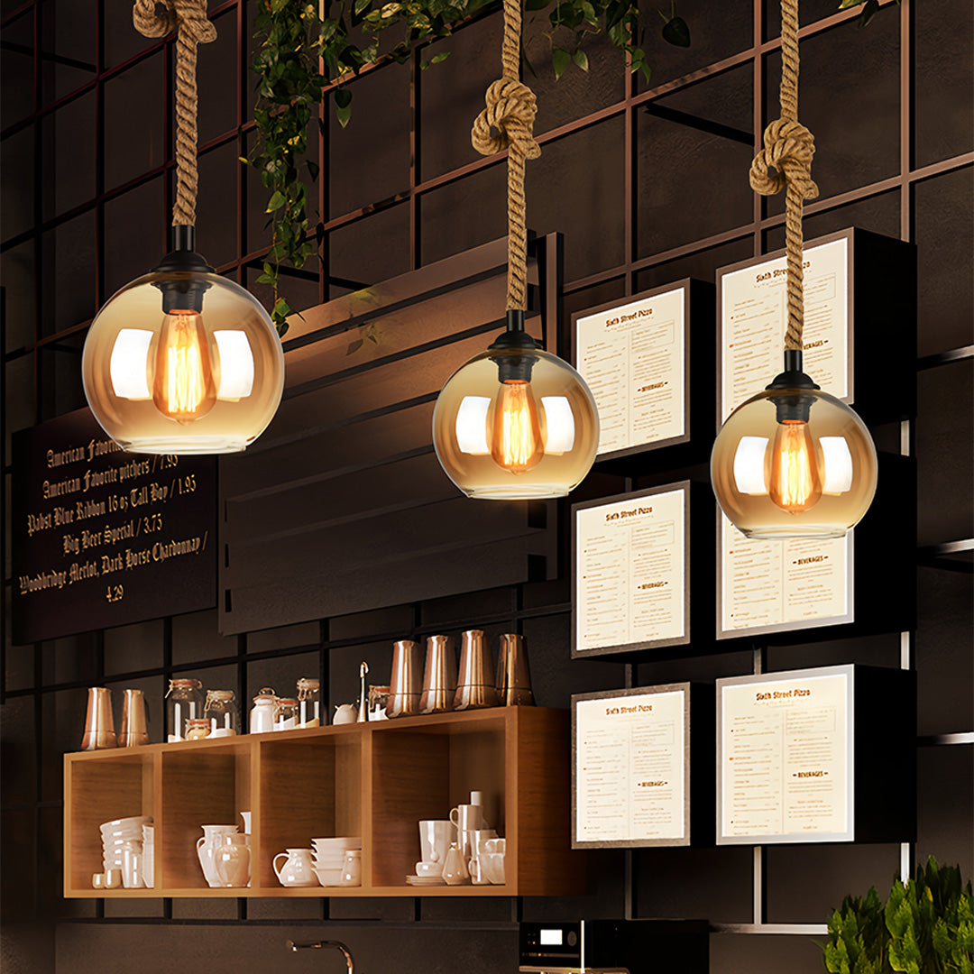 Retro glass pendant lights with warm glow enhancing cozy wine bar atmosphere.