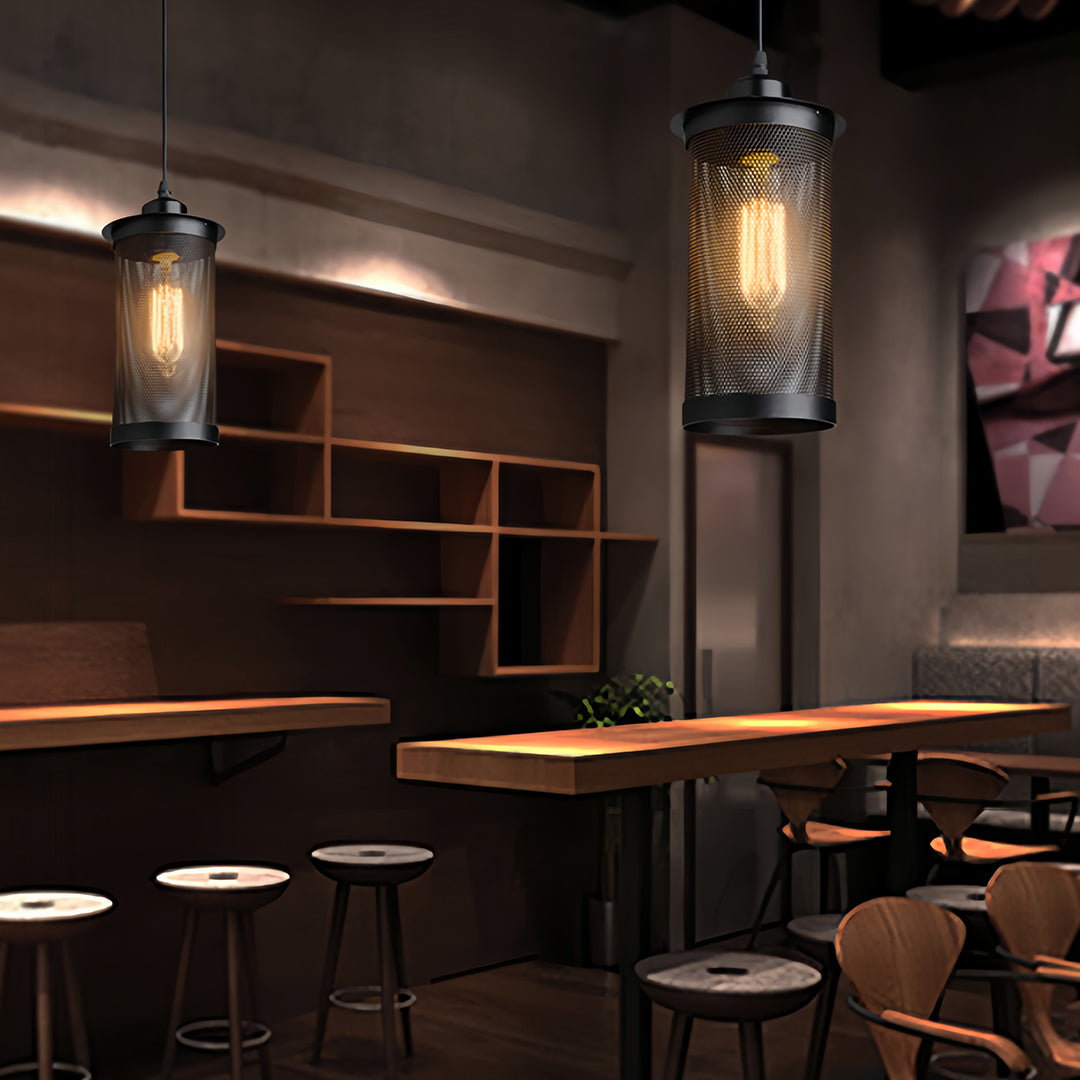 Hanging retro industrial pendant lights illuminating a modern minimalist bar area with dark stools and open shelving.