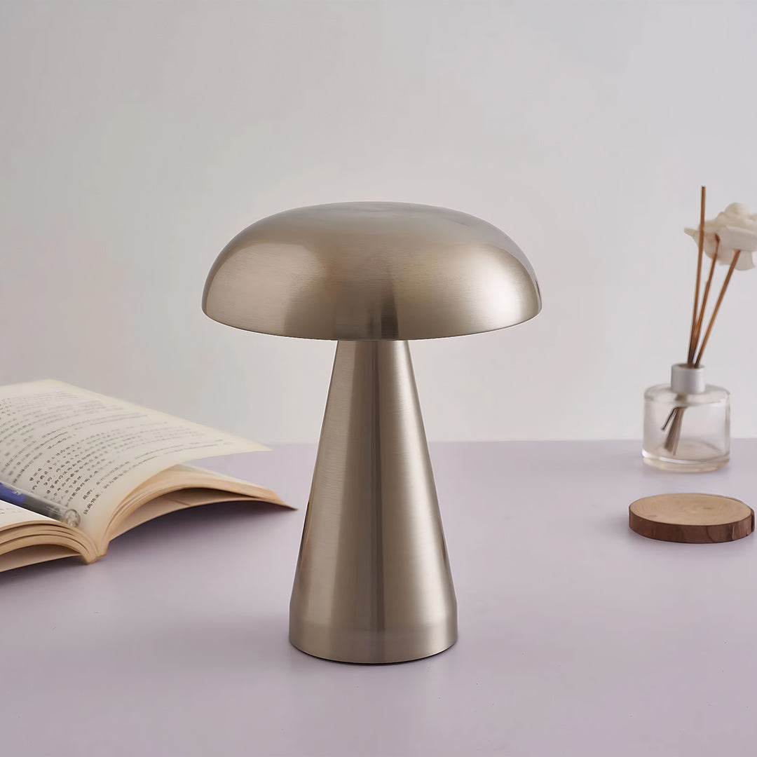 Retro metal table lamp in pewter tone creating ambient lighting on minimal tabletop