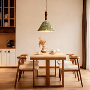 Retro pendant lighting illuminating dining area with wooden table and chairs creating warm ambient atmosphere