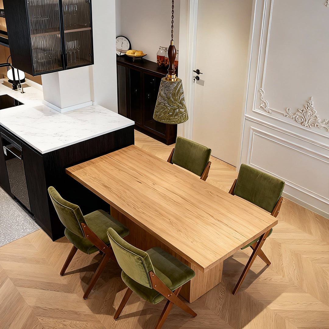 Retro pendant lighting hanging above dining table in modern space with white brick walls and minimalist decor