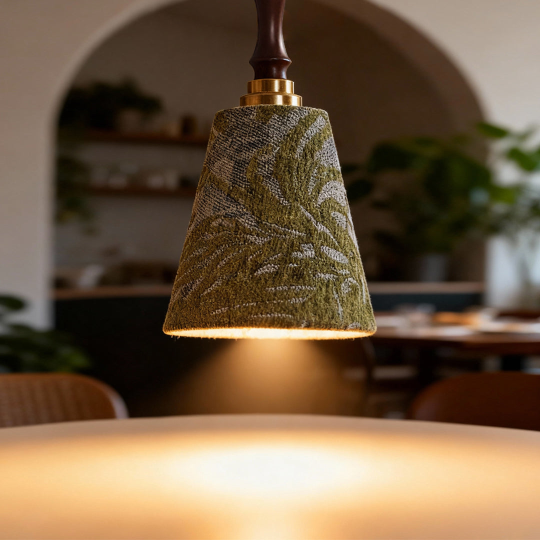 Retro pendant lighting providing task lighting over counter space with decorative perforated shade casting patterns