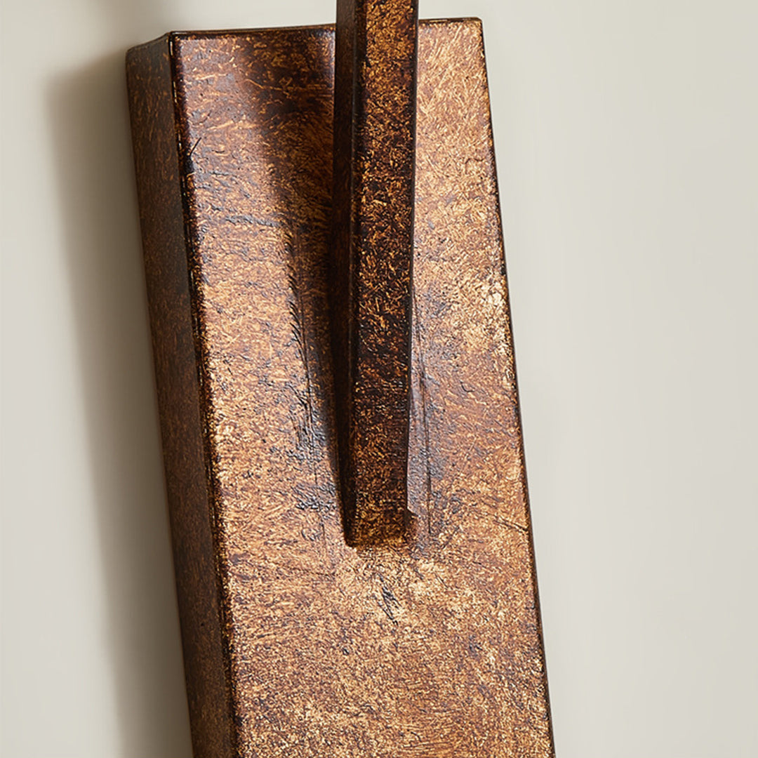 Close-up detail of retro wall lights showing textured metallic finish and angular mounting hardware design