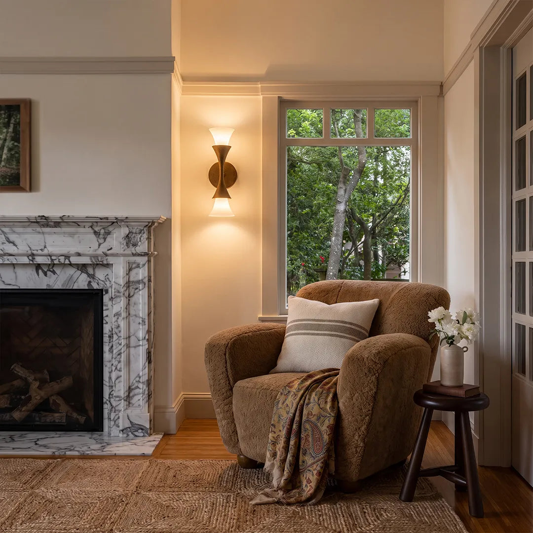 Retro wall sconce installed beside a fireplace seating area with warm decorative lighting.
