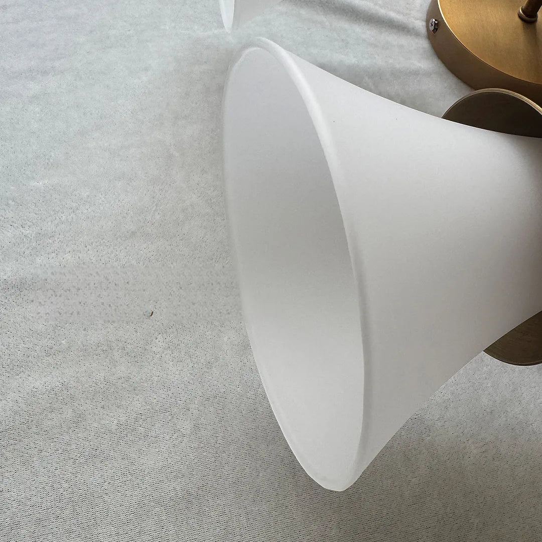 Retro wall sconce close-up highlighting the frosted white flared glass shade.