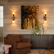 Retro wall sconce pair flanking wall art in a cozy living room with warm ambient lighting.