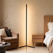 RGB corner floor lamp illuminating a cozy bedroom with warm white light.