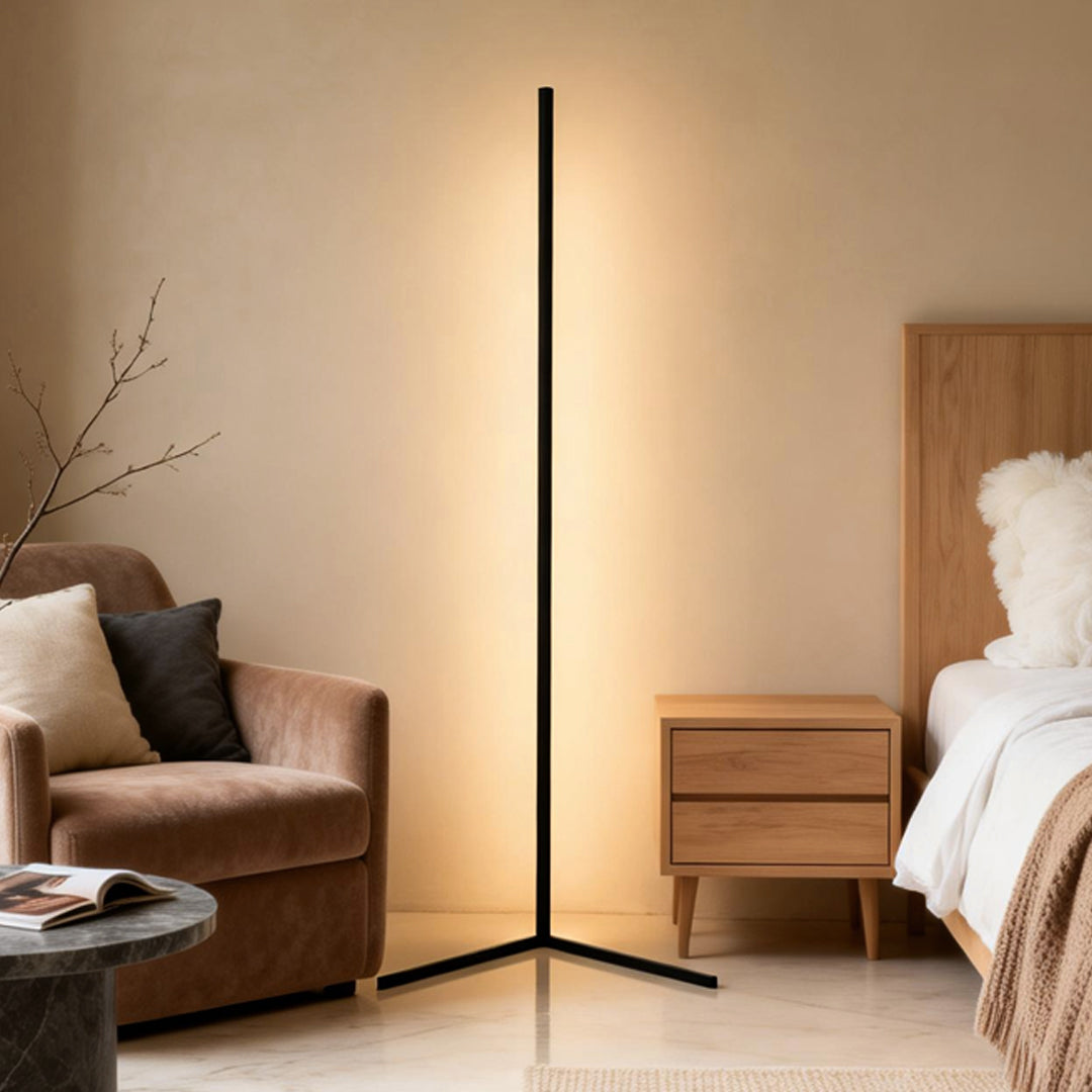 RGB corner floor lamp illuminating a cozy bedroom with warm white light.