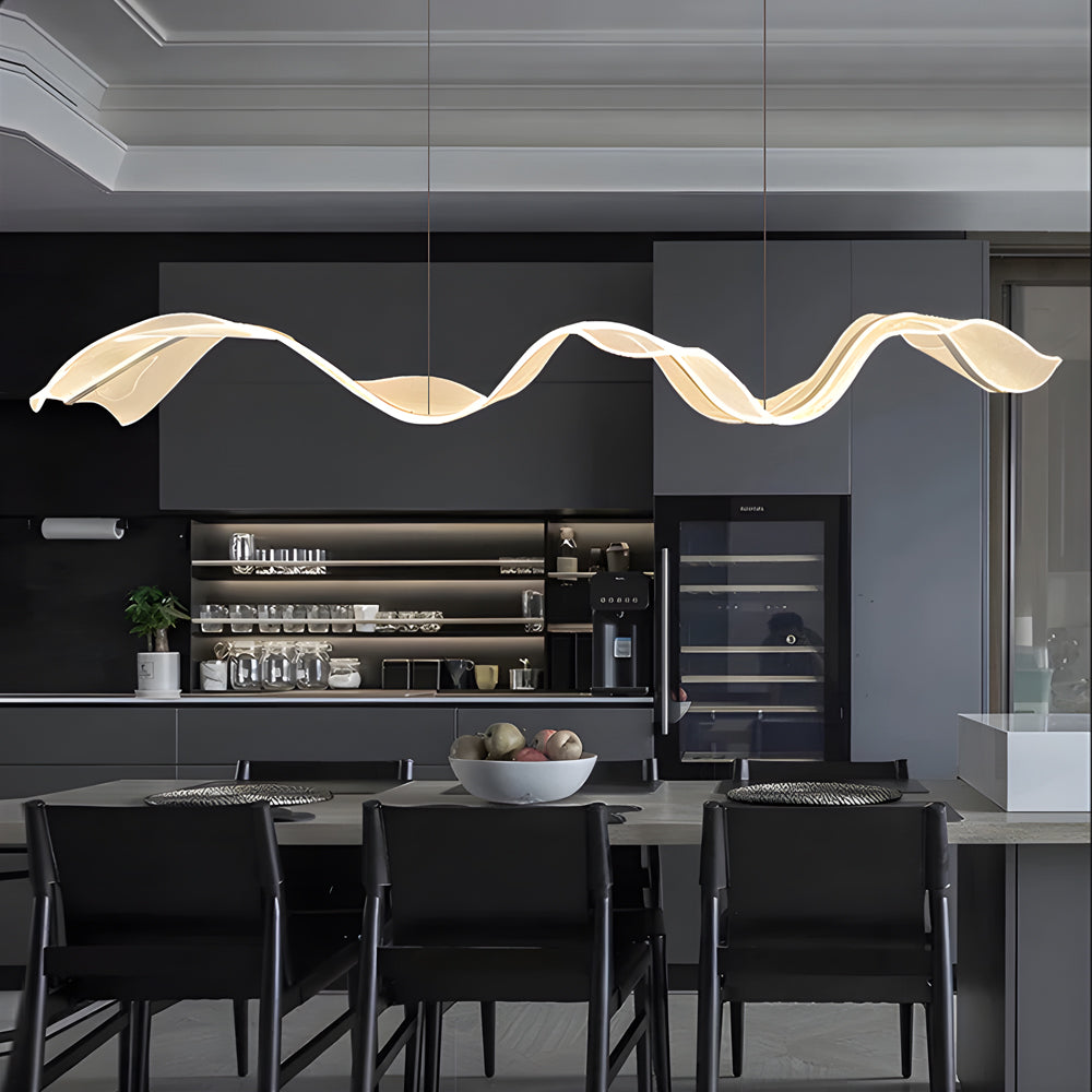 Ribbon pendant light with a golden wave design, providing ambient lighting in a stylish kitchen.