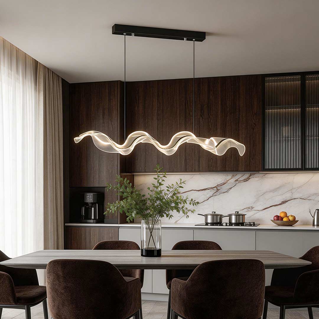 Ribbon pendant light with a modern wave design, hanging above a dining table in a contemporary kitchen.