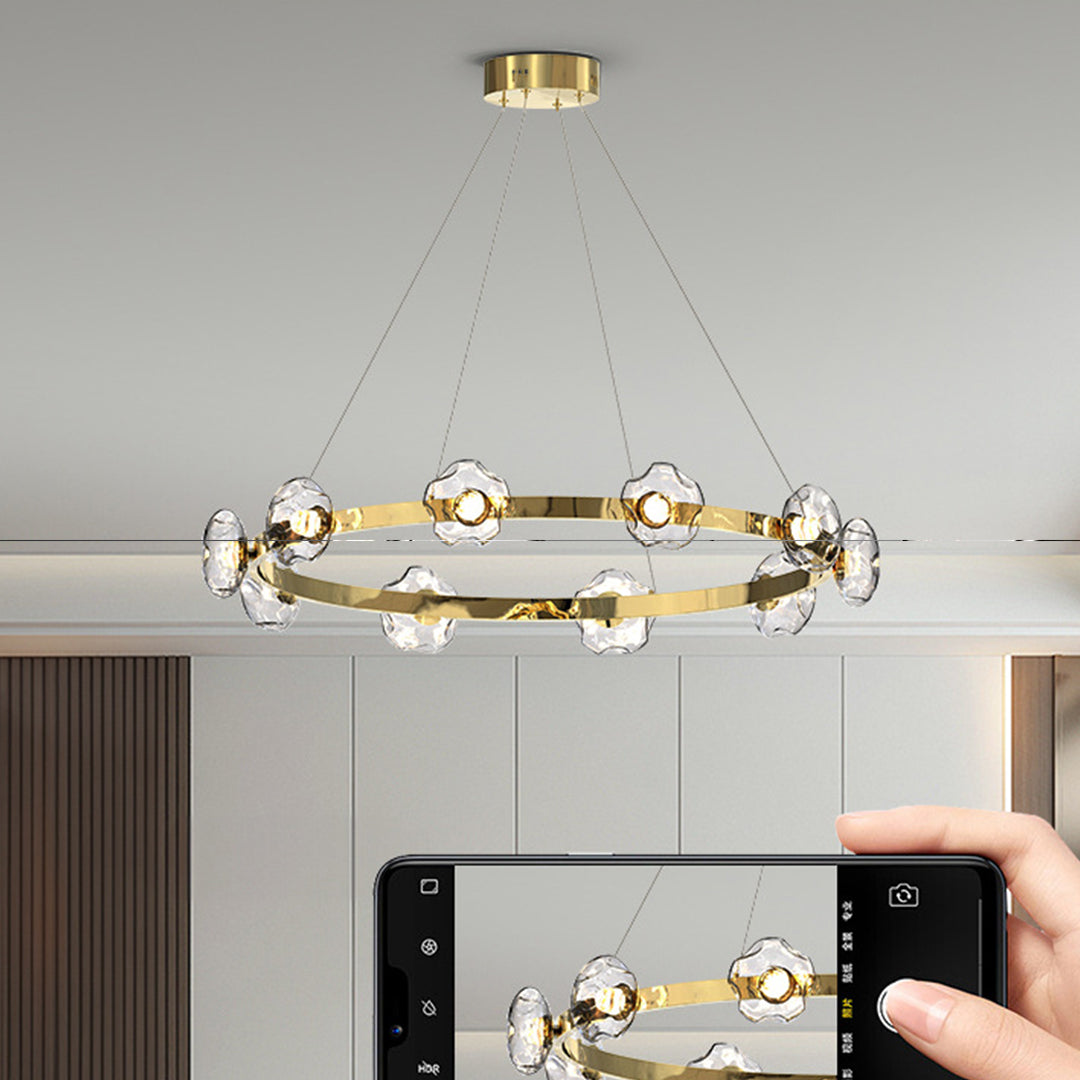 Ring chandelier installation in modern kitchen dining area with sophisticated glass orb lighting design