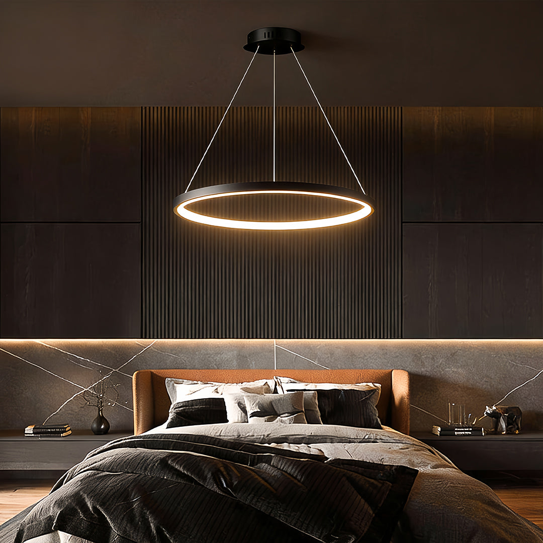 Ring chandelier LED suspended above a modern bedroom, emitting a warm circular glow that enhances the cozy and contemporary interior atmosphere.