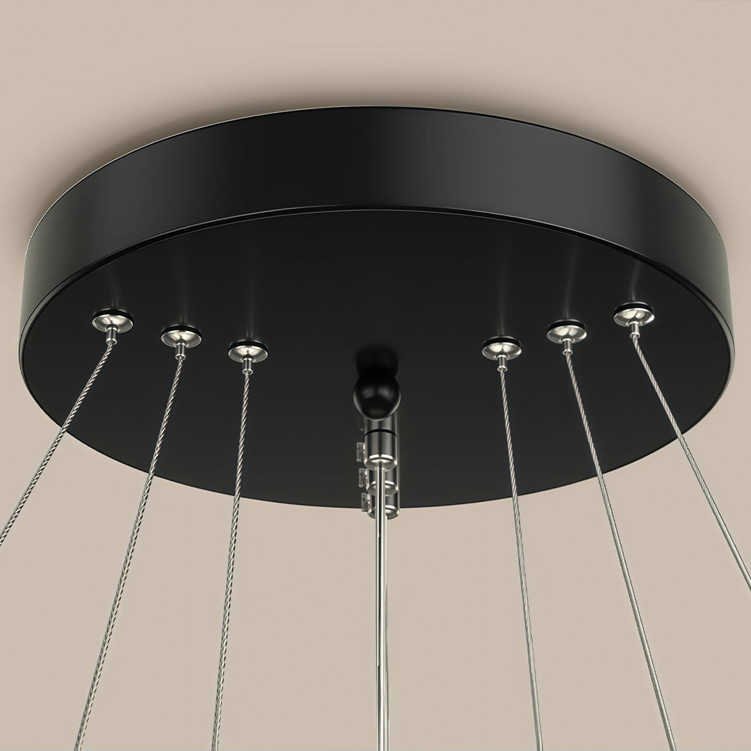 Modern ring LED chandelier above dining table close-up view.