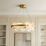 Elegant ring-shaped copper modern chandelier featuring faux alabaster stone panels illuminating an upscale room.