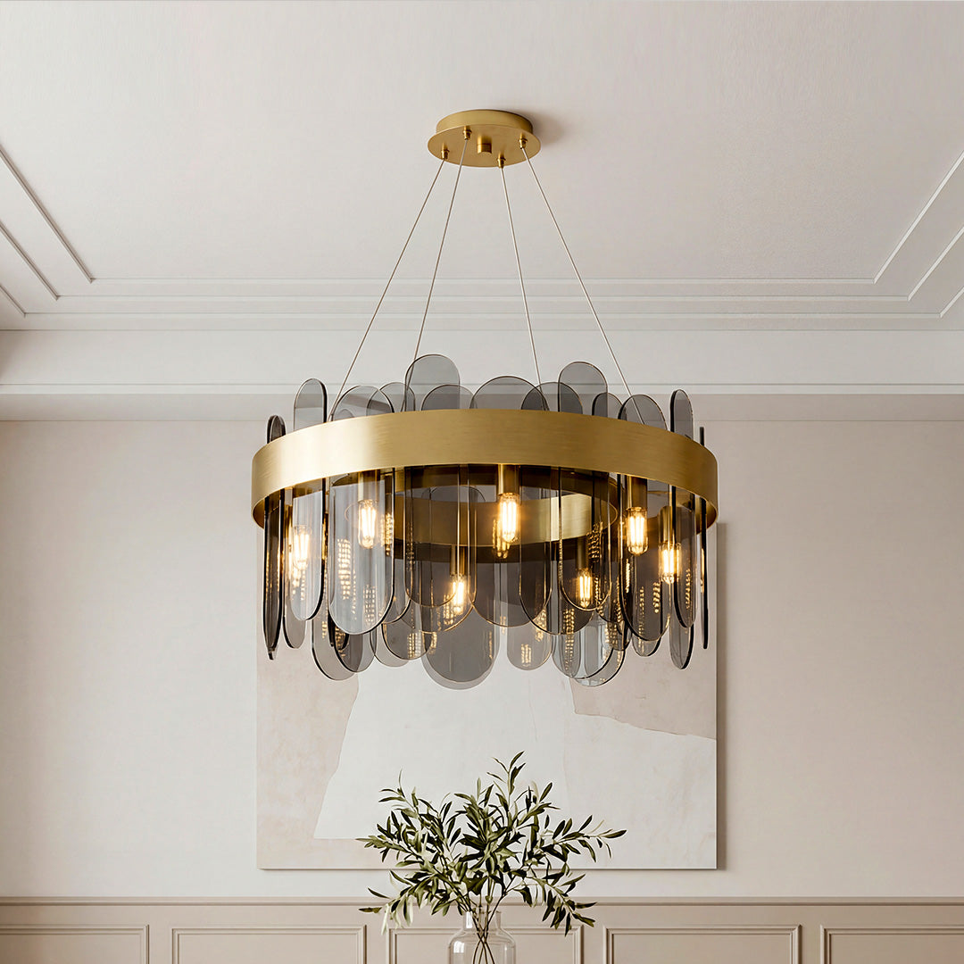 Sophisticated ring-shaped modern traditional chandeliers featuring a wide gold band and sleek smoky glass panels in an elegant room.