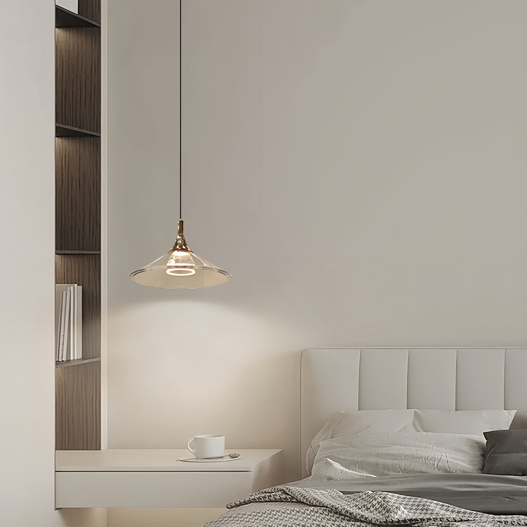 Rise and fall pendant lights suspended above contemporary bedroom with tufted headboard and soft linens
