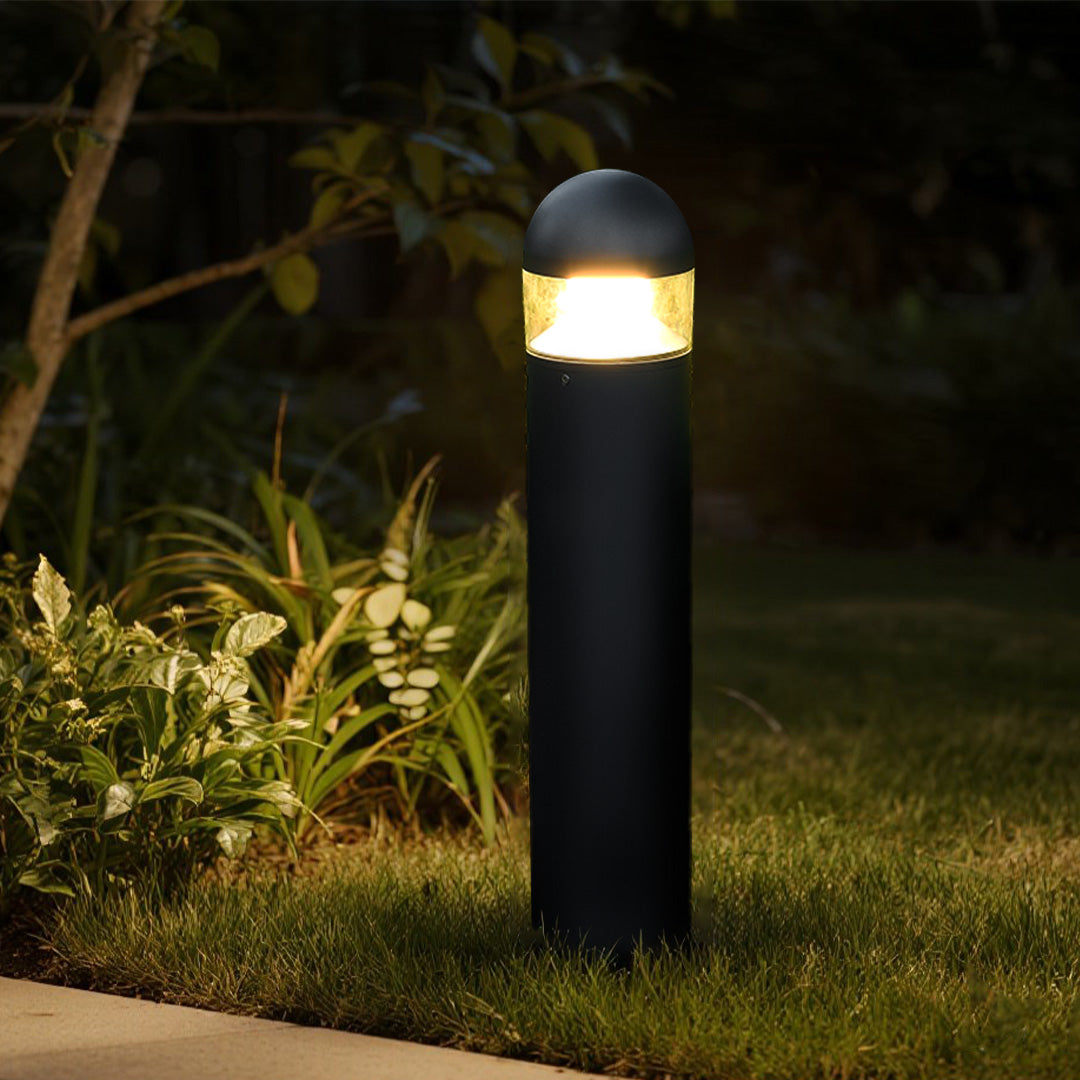 Modern bollard lights illuminating natural rock garden with ambient lighting effects