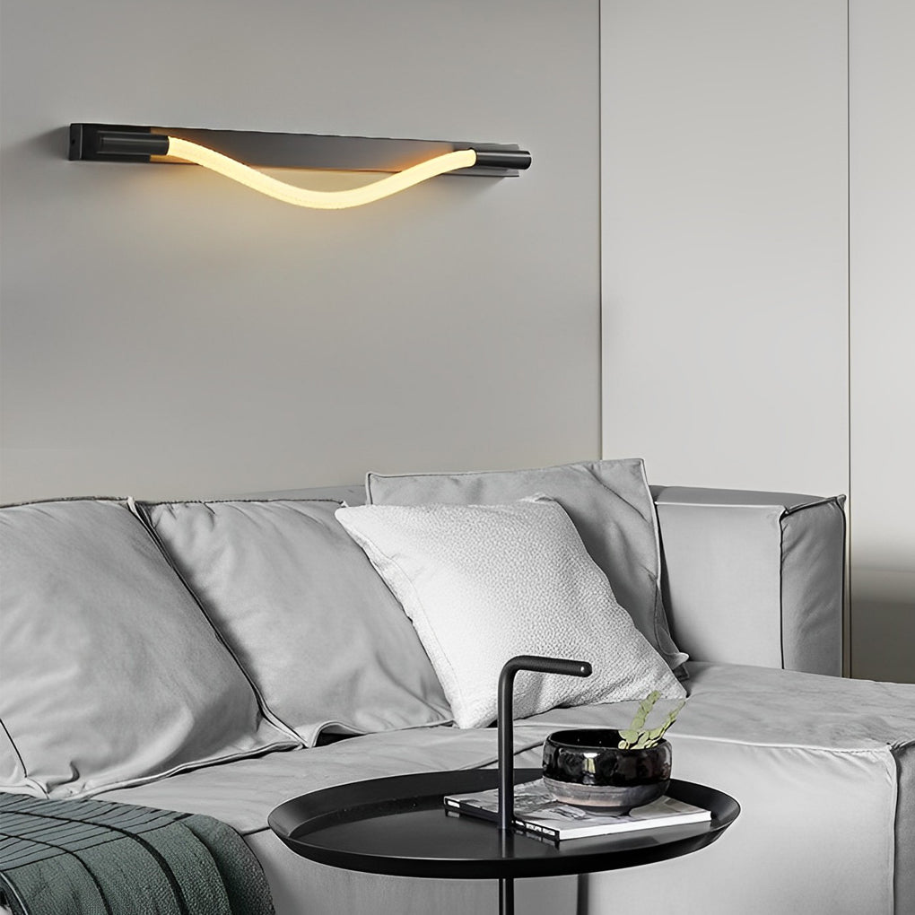 Rope wall sconce light with a minimalist design, illuminating a contemporary bedroom.