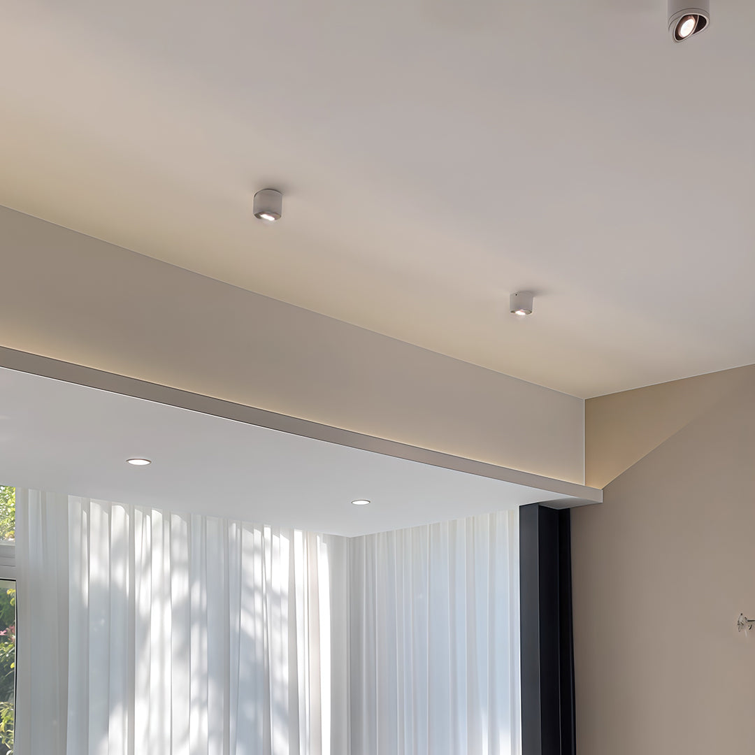 Rotating spotlights accenting minimalist hallway with white curtains and clean architectural lines