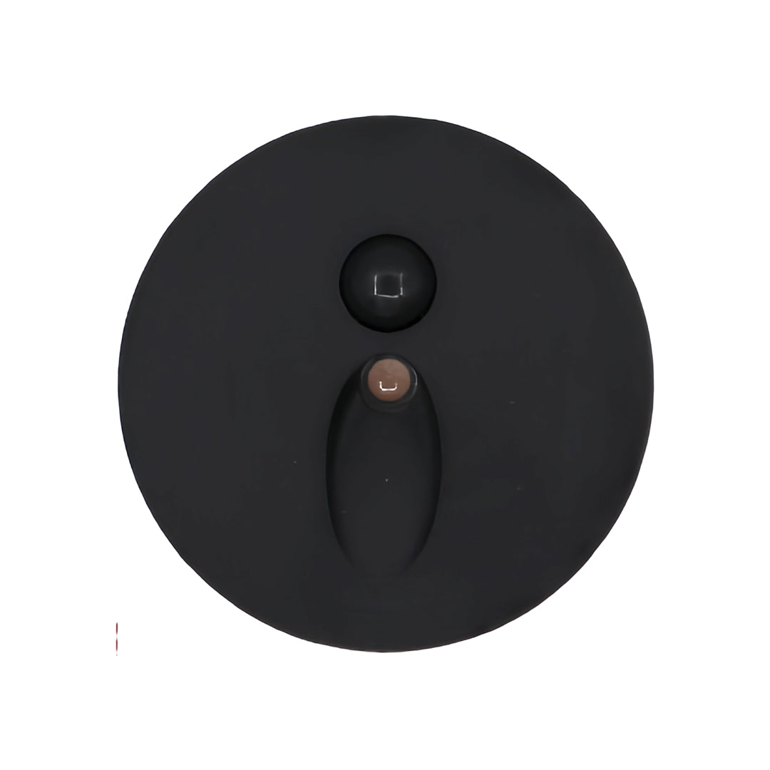 Round black interior stair step lights with a subtle oval light beam, featuring a durable metal trim and integrated sensor for low-level path lighting in dark hallways.