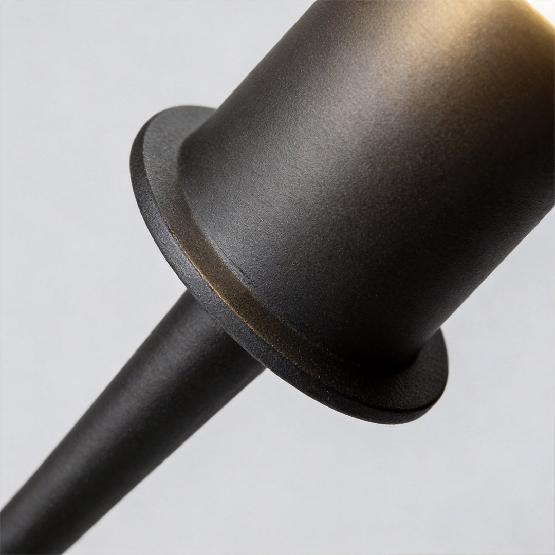 Round bollard lights with a black finish, providing soft illumination near a house entrance.