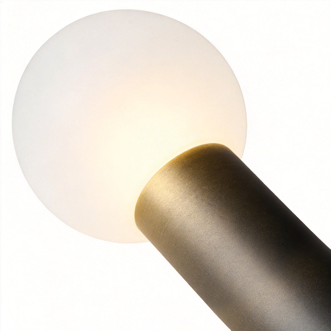 Round bollard lights with a close-up of their illuminated spherical top.