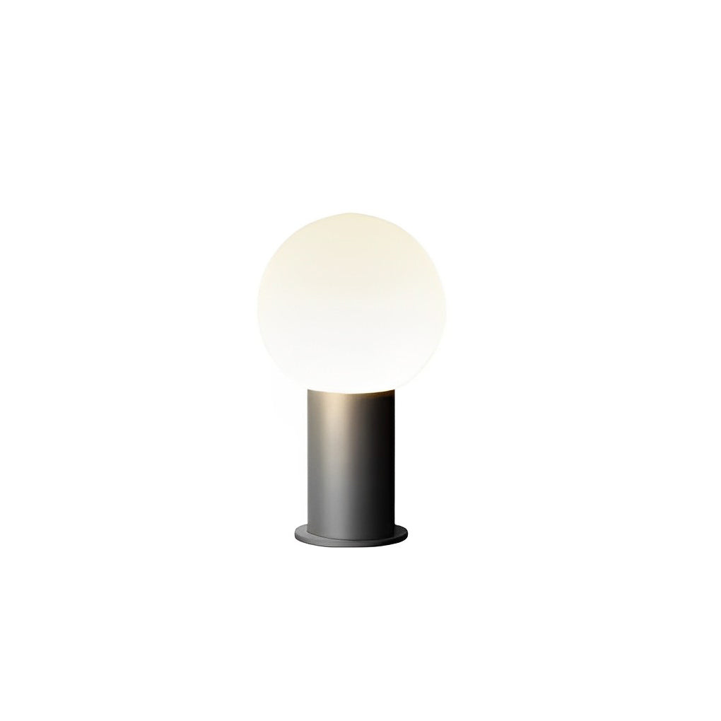 Round bollard lights with a modern design, providing elegant lighting in a garden.