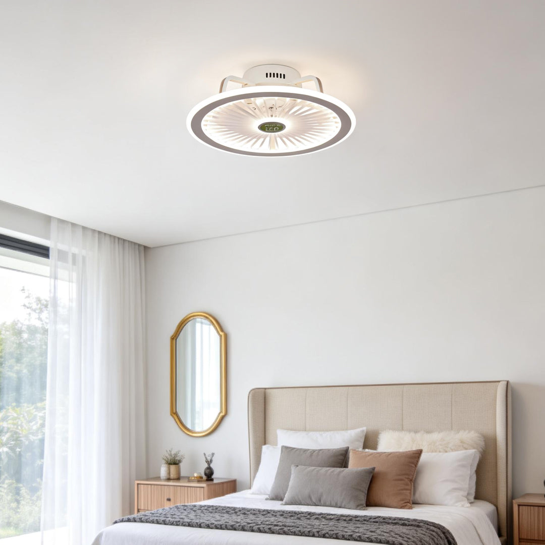 White round ceiling fan with integrated LED light in minimalist bedroom.