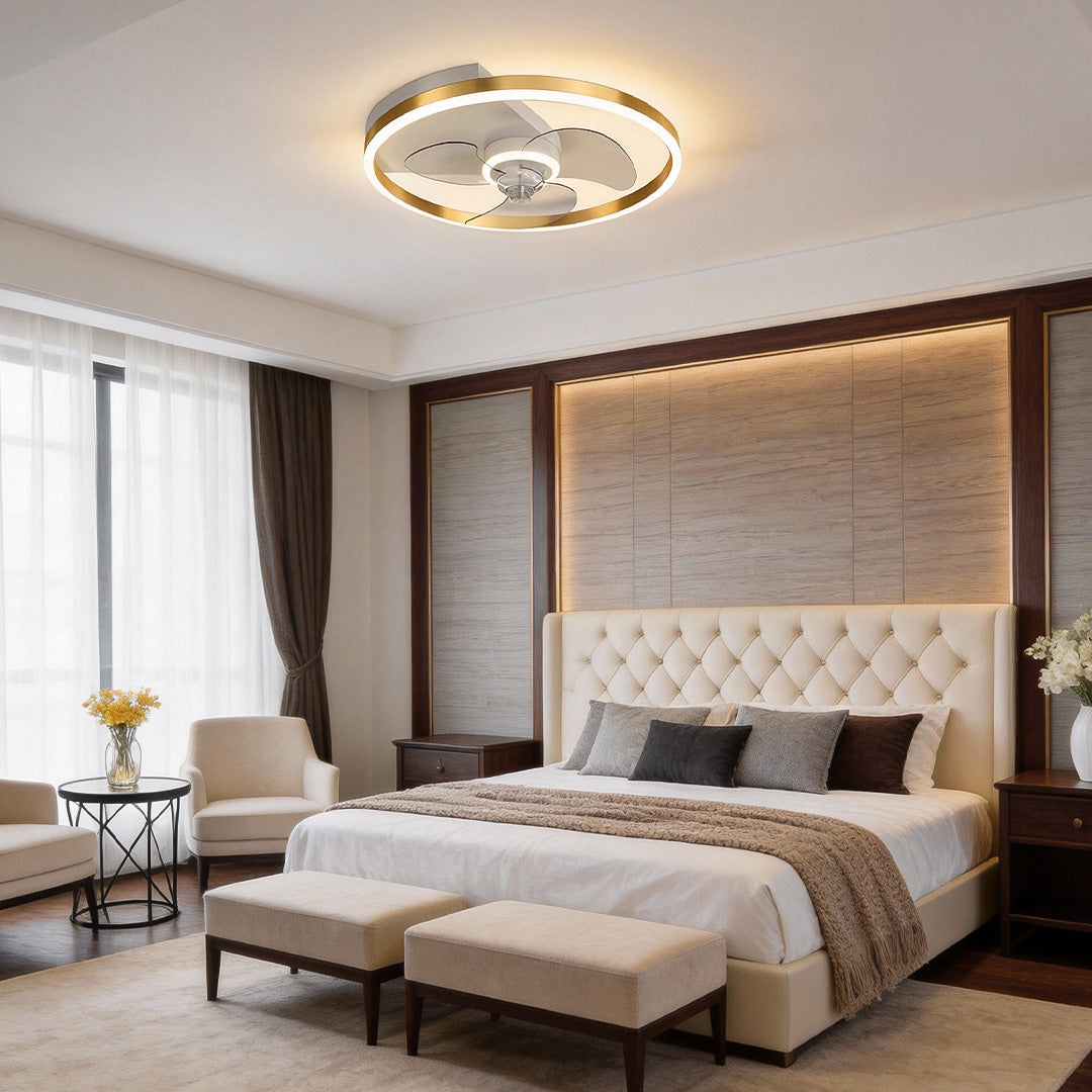 Round ceiling fan with light adding elegance to a luxurious bedroom with tufted headboard.