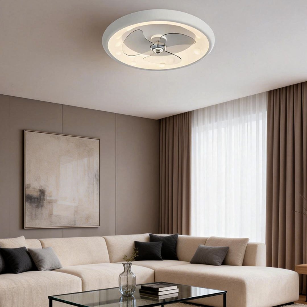 Round ceiling fan with light illuminating a modern living room with a beige sofa and curtains.