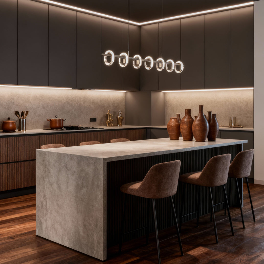 Modern kitchen island featuring a round chandelier with multiple illuminated rings in a clean contemporary style.