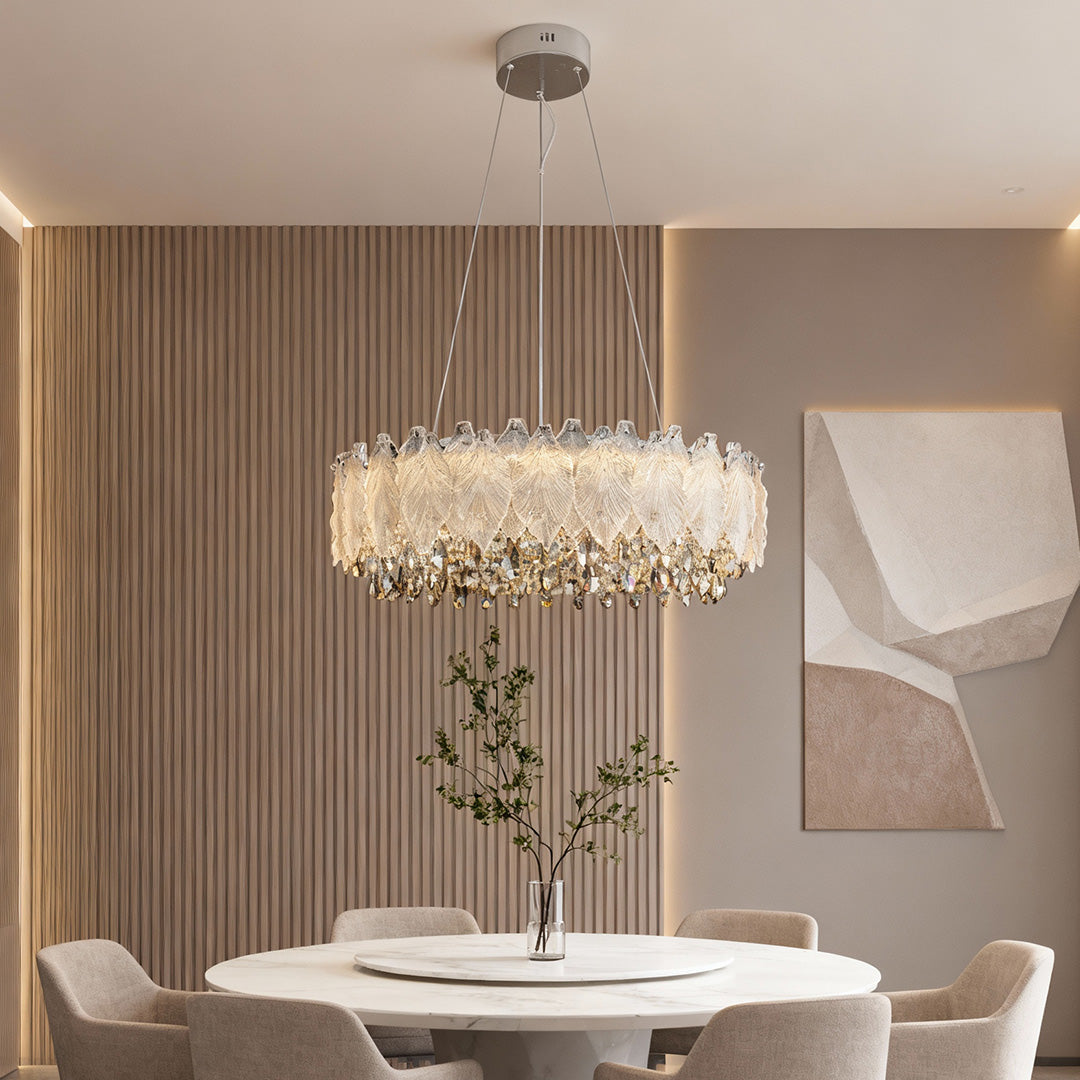 Round French country chandelier illuminating neutral dining room with wall art.