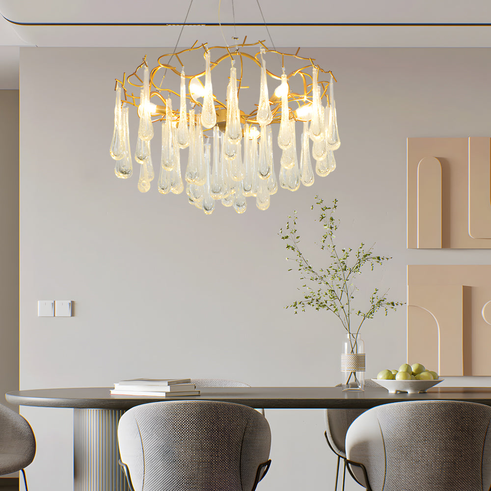 Round crystal modern chandelier hanging above a stylish dining table in an open home.