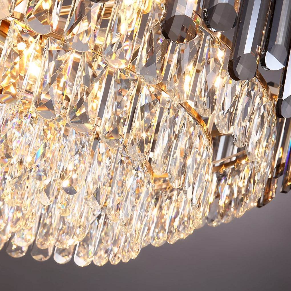 Round drum crystal chandelier casting a soft glow in a luxurious bedroom setting.