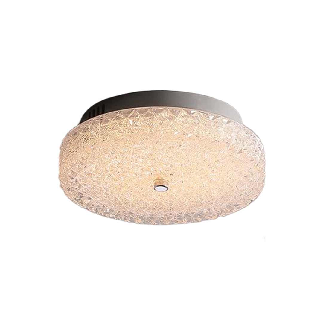 Round flush mount crystal ceiling light with a metallic frame, showcasing a sleek and modern design.