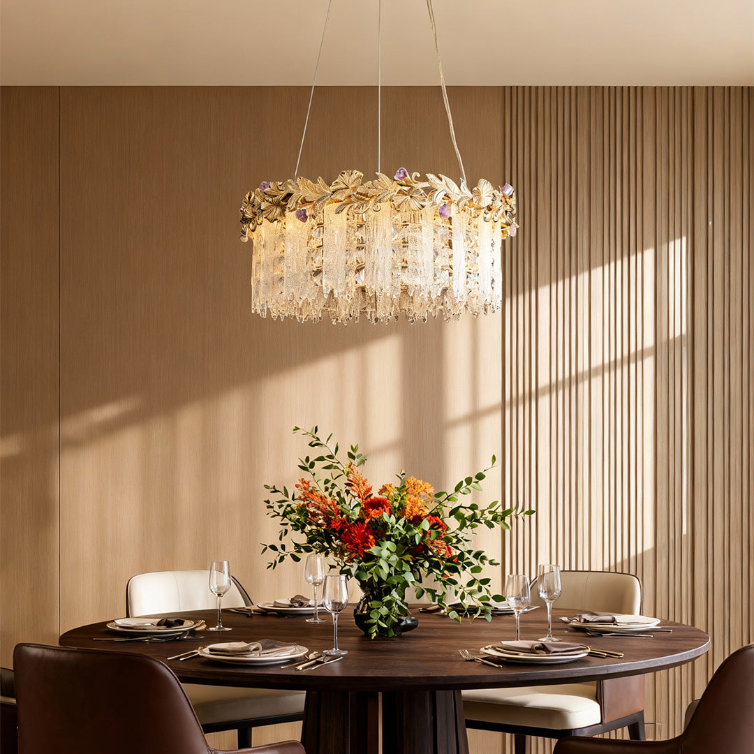 Round gold chandelier crystal lighting up a dining space with floral decor.