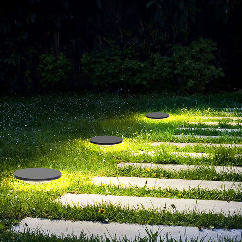 Round lawn lights guiding outdoor steps and walkways at night