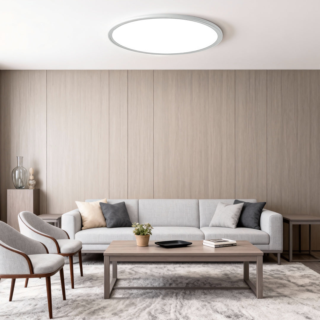 Minimalist round LED ceiling light in a neutral-toned living room